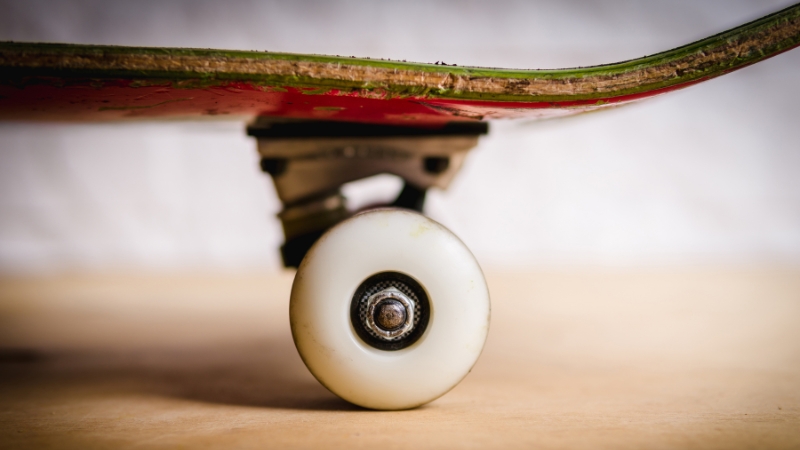Close-up view of skateboard trucks and wheel attached to the deck